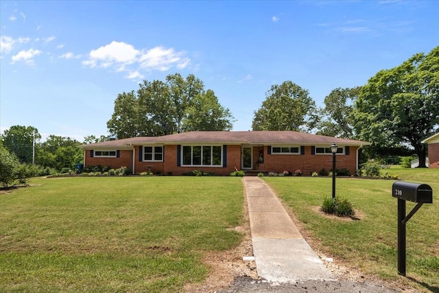 210 Lankford St, Bruceton, TN 38317 - single story home with a front lawn and brick siding