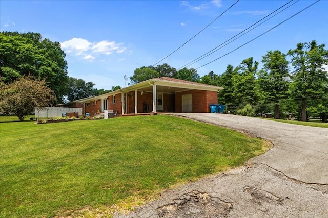210 Lankford St, Bruceton, TN 38317 - view of front facade with driveway, a front yard, brick siding, and a porch
