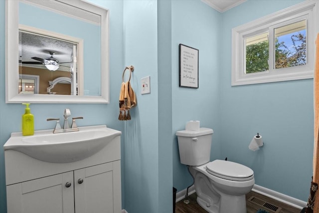 210 Lankford St, Bruceton, TN 38317 - bathroom with baseboards, vanity, toilet, crown molding, and ceiling fan