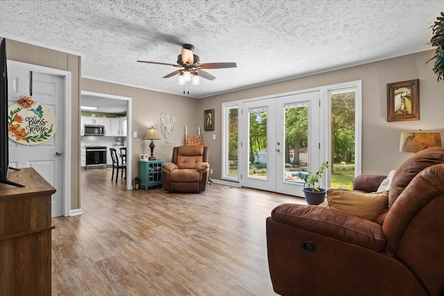 210 Lankford St, Bruceton, TN 38317 - living area featuring french doors, ceiling fan, wood finished floors, a textured ceiling, and crown molding