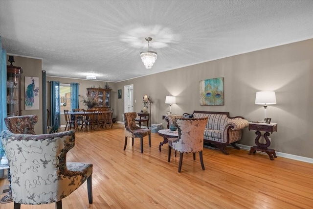 210 Lankford St, Bruceton, TN 38317 - living area featuring a textured ceiling, light wood-type flooring, and baseboards