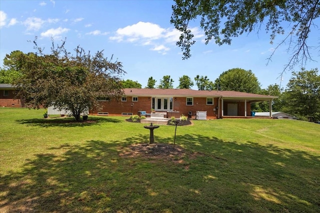 210 Lankford St, Bruceton, TN 38317 - back of house featuring a lawn and brick siding