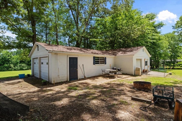210 Lankford St, Bruceton, TN 38317 - view of outbuilding with a fire pit