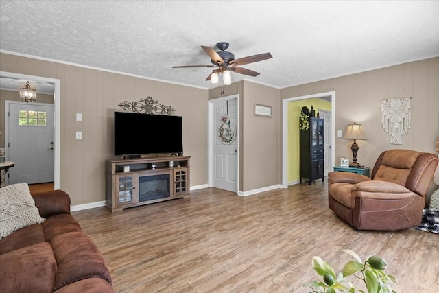 210 Lankford St, Bruceton, TN 38317 - living area with ceiling fan, wood finished floors, ornamental molding, a textured ceiling, and baseboards
