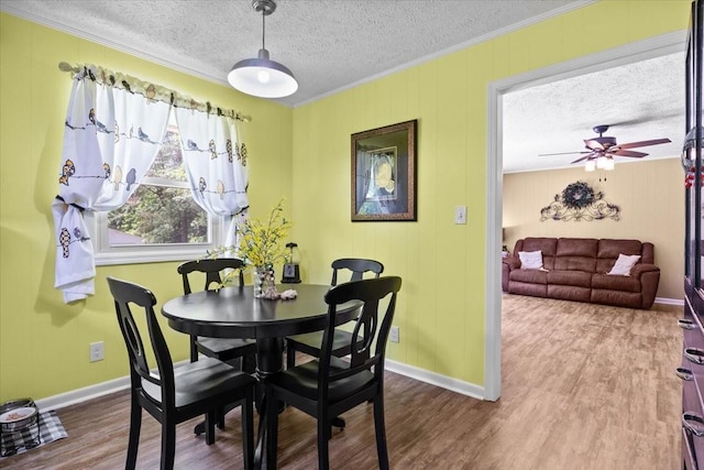 210 Lankford St, Bruceton, TN 38317 - dining room featuring a textured ceiling, ornamental molding, ceiling fan, baseboards, and wood finished floors