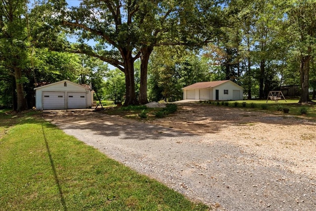 210 Lankford St, Bruceton, TN 38317 - view of yard with a garage, an outdoor structure, and view of scattered trees