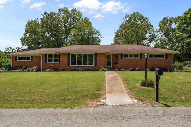 210 Lankford St, Bruceton, TN 38317 - single story home featuring a front yard and brick siding