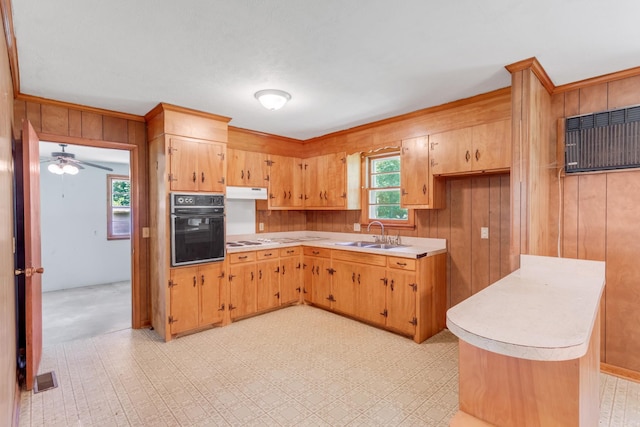 7111 Harrison Dr, Fairview, TN 37062 - kitchen with black oven, wooden walls, light countertops, under cabinet range hood, and a ceiling fan