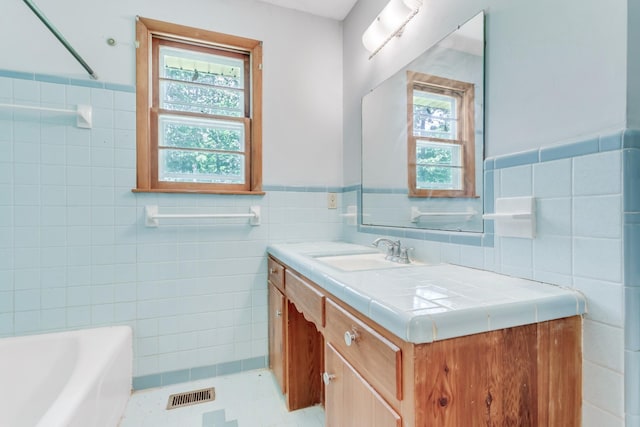 7111 Harrison Dr, Fairview, TN 37062 - full bathroom with tile walls, vanity, a bath, wainscoting, and tile patterned floors