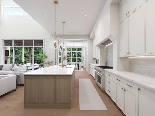1316 Mcquiddy Rd, Nashville, TN 37221 - kitchen with range with two ovens, decorative backsplash, a sink, a kitchen island with sink, and white cabinets