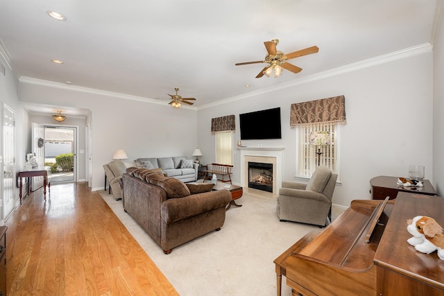 646 Forest Glen Cir, Murfreesboro, TN 37128 - living room featuring ceiling fan, crown molding, a glass covered fireplace, baseboards, and light wood-style flooring