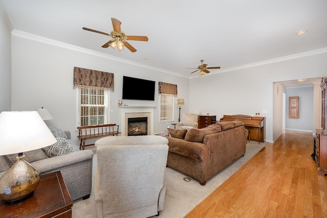 646 Forest Glen Cir, Murfreesboro, TN 37128 - living room featuring a ceiling fan, ornamental molding, a lit fireplace, light wood-style floors, and baseboards