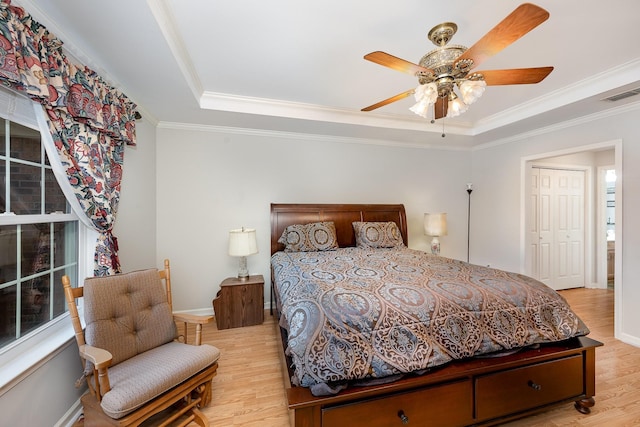 646 Forest Glen Cir, Murfreesboro, TN 37128 - bedroom with a raised ceiling, light wood finished floors, ornamental molding, ceiling fan, and baseboards