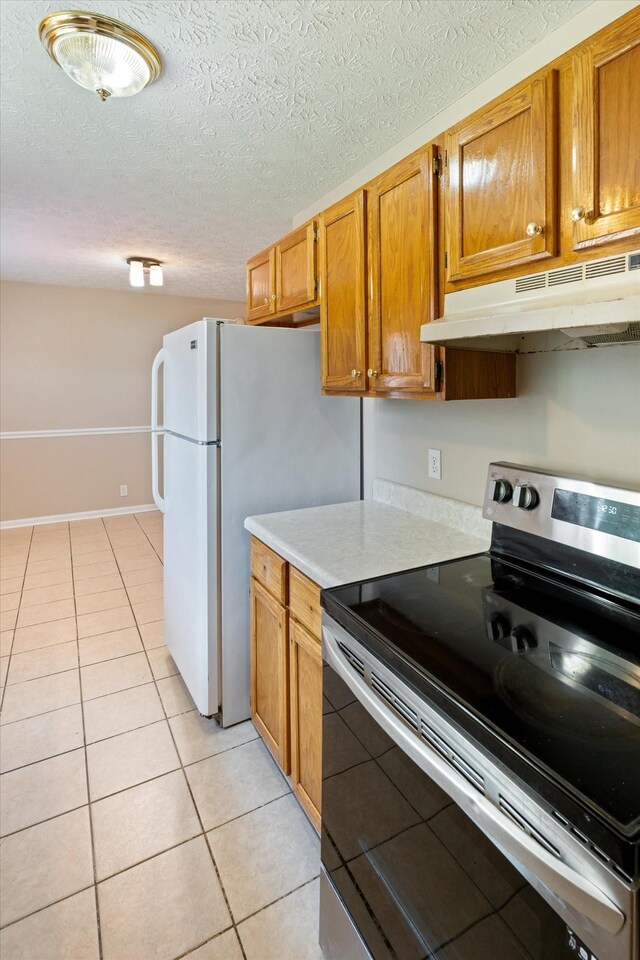 104 Hillcreek Ct, Portland, TN 37148 - kitchen featuring stainless steel electric stove, under cabinet range hood, light countertops, light tile patterned floors, and a textured ceiling