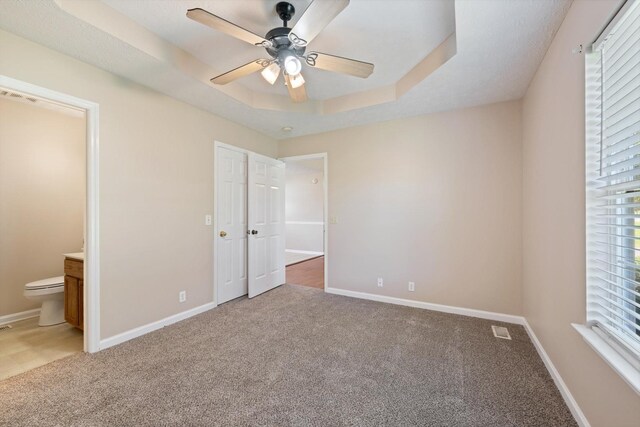104 Hillcreek Ct, Portland, TN 37148 - unfurnished bedroom featuring light carpet, a tray ceiling, and baseboards