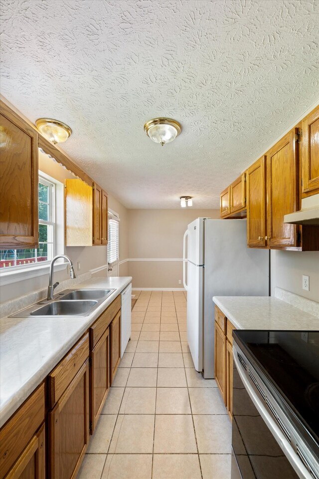 104 Hillcreek Ct, Portland, TN 37148 - kitchen with a sink, white appliances, light countertops, light tile patterned flooring, and a textured ceiling