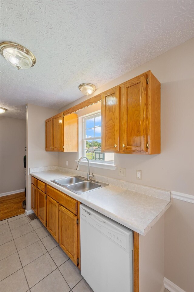 104 Hillcreek Ct, Portland, TN 37148 - kitchen with a sink, white dishwasher, light countertops, light tile patterned flooring, and baseboards