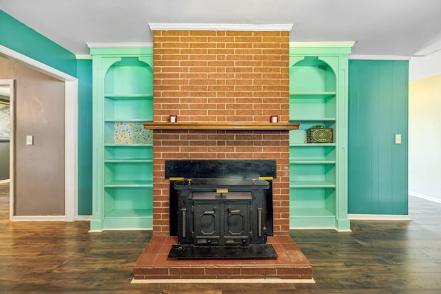 414 Ashe Ave, New Johnsonville, TN 37134 - living room featuring baseboards, a wood stove, built in features, wood finished floors, and crown molding