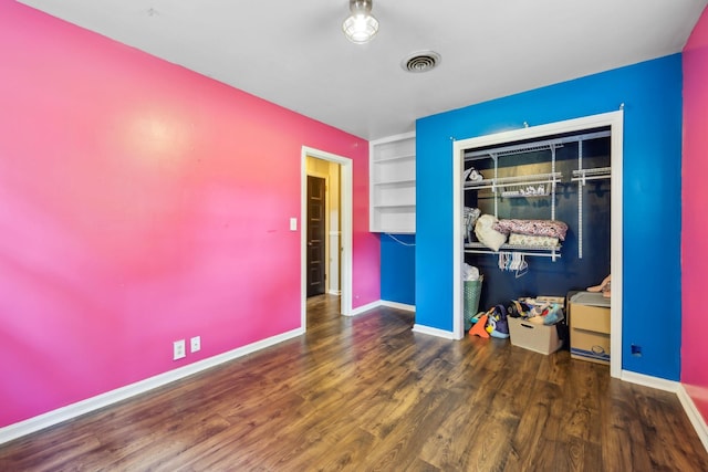 414 Ashe Ave, New Johnsonville, TN 37134 - unfurnished bedroom with wood finished floors, a closet, and baseboards