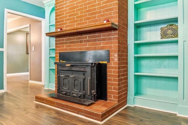 414 Ashe Ave, New Johnsonville, TN 37134 - detailed view of baseboards, a fireplace, built in shelves, and wood finished floors