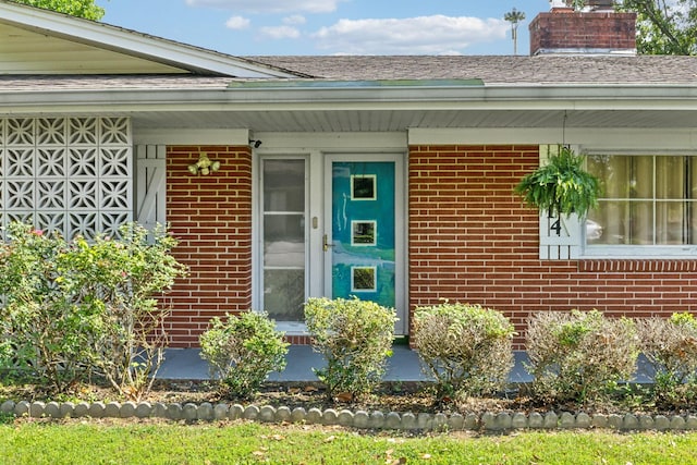 414 Ashe Ave, New Johnsonville, TN 37134 - entrance to property featuring brick siding, a chimney, and roof with shingles