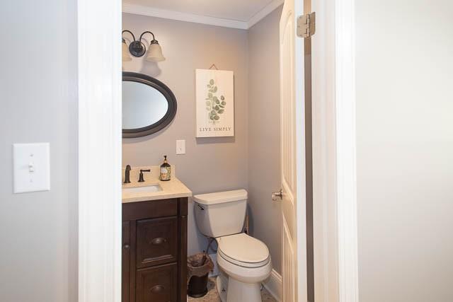 6684 Eudailey Covington Rd, College Grove, TN 37046 - bathroom featuring vanity, toilet, and crown molding