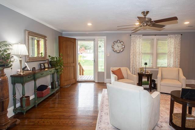 6684 Eudailey Covington Rd, College Grove, TN 37046 - living room with crown molding, healthy amount of natural light, wood finished floors, a ceiling fan, and baseboards