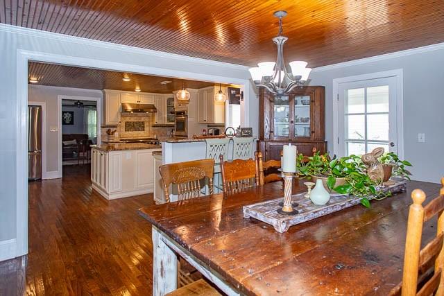 6684 Eudailey Covington Rd, College Grove, TN 37046 - dining area with ornamental molding, a chandelier, dark wood-type flooring, and wooden ceiling