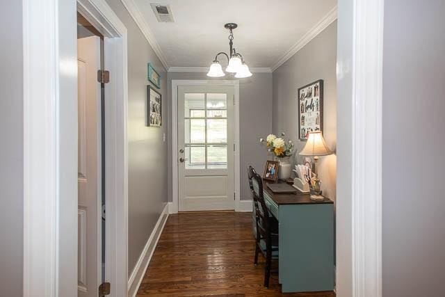 6684 Eudailey Covington Rd, College Grove, TN 37046 - doorway to outside featuring dark wood finished floors, a chandelier, crown molding, and baseboards