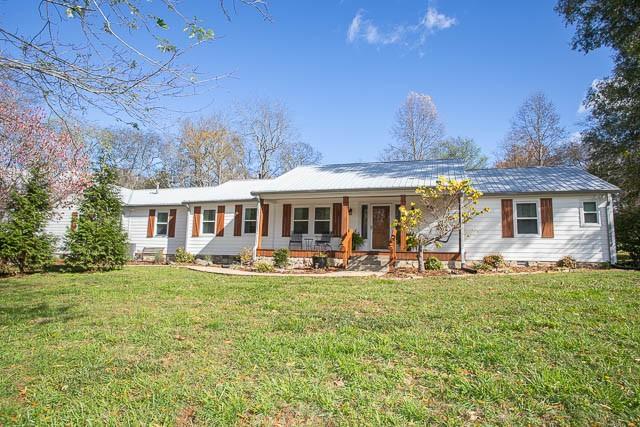 6684 Eudailey Covington Rd, College Grove, TN 37046 - ranch-style house with a porch and a front lawn
