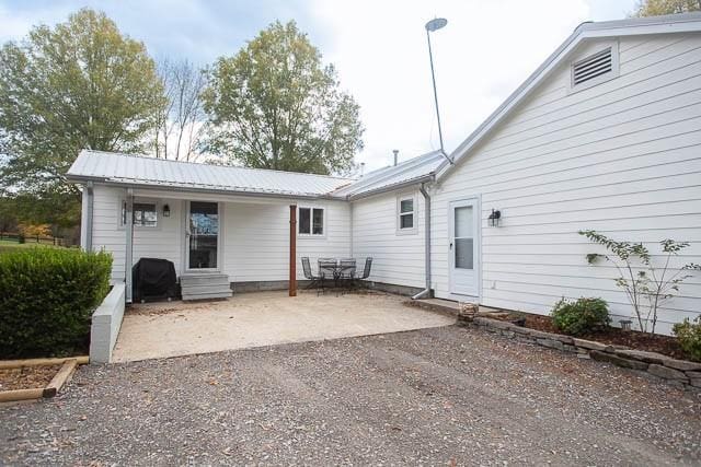 6684 Eudailey Covington Rd, College Grove, TN 37046 - back of property featuring a patio and metal roof
