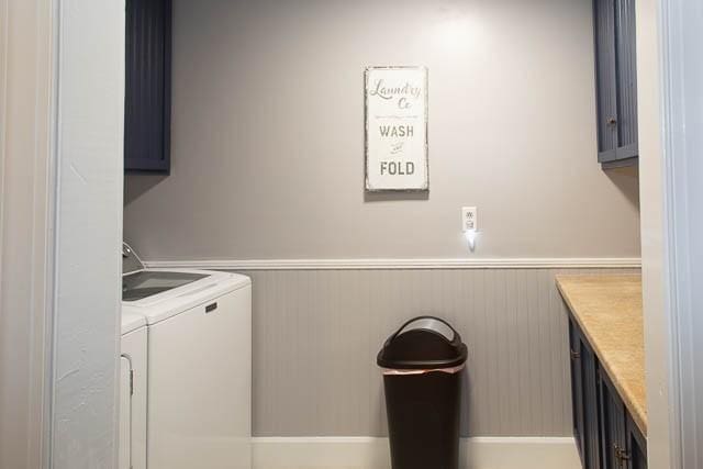 6684 Eudailey Covington Rd, College Grove, TN 37046 - laundry room featuring cabinet space, washer and dryer, and wainscoting