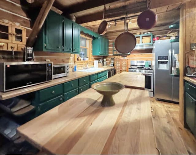 268 Sugar Maple Dr, Dover, TN 37058 - kitchen with stainless steel appliances, green cabinetry, light wood-style floors, a sink, and butcher block counters