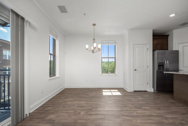 1021 Vida Way Unit 202, Nolensville, TN 37135 - unfurnished dining area with a chandelier, dark wood-type flooring, baseboards, and crown molding