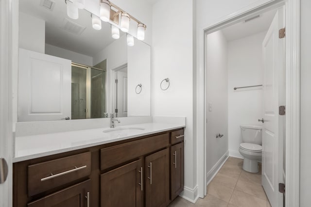 1021 Vida Way Unit 202, Nolensville, TN 37135 - bathroom featuring vanity, toilet, tile patterned floors, a stall shower, and baseboards