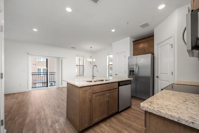 1021 Vida Way Unit 202, Nolensville, TN 37135 - kitchen featuring a sink, stainless steel appliances, wood finished floors, a chandelier, and ornamental molding