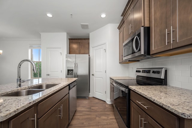 1021 Vida Way Unit 202, Nolensville, TN 37135 - kitchen featuring stainless steel appliances, a sink, backsplash, dark wood-style floors, and light stone countertops