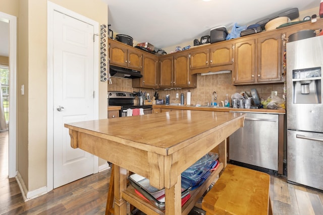221 Pitts Ave, Old Hickory, TN 37138 - kitchen with appliances with stainless steel finishes, under cabinet range hood, dark wood-style floors, a sink, and tasteful backsplash