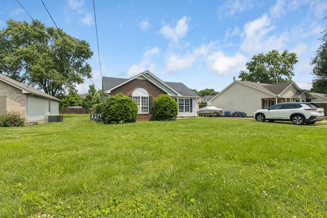 221 Pitts Ave, Old Hickory, TN 37138 - view of front facade featuring brick siding, central air condition unit, and a front lawn