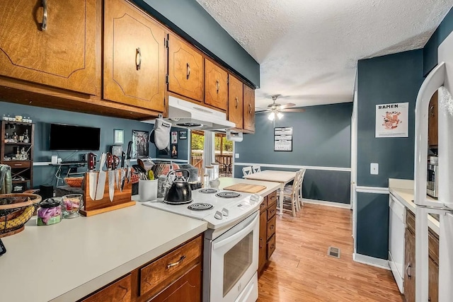 3225 Towne Village Rd E, Antioch, TN 37013 - kitchen featuring white appliances, brown cabinets, light countertops, a ceiling fan, and arched walkways