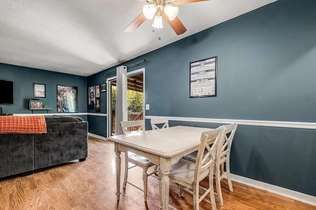 3225 Towne Village Rd E, Antioch, TN 37013 - dining room featuring ceiling fan, wood finished floors, a textured ceiling, and a wainscoted wall