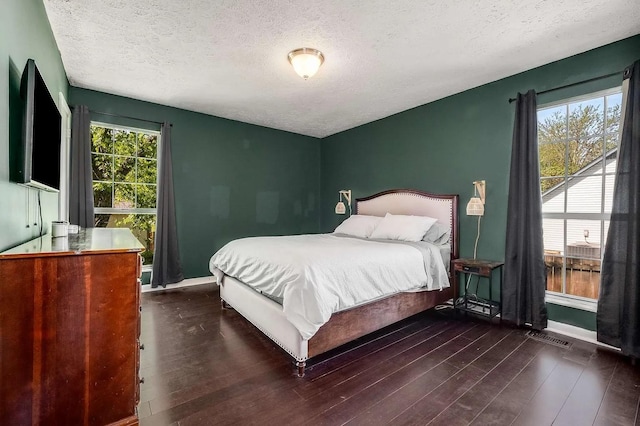 3225 Towne Village Rd E, Antioch, TN 37013 - bedroom with a textured ceiling, baseboards, and wood finished floors