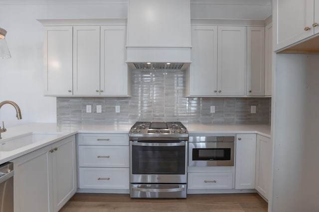 3174 Long Branch Cir, Franklin, TN 37064 - kitchen featuring stainless steel appliances, custom exhaust hood, a sink, and light countertops