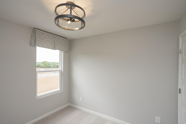5047 Dayflower Dr, Hermitage, TN 37076 - spare room featuring a chandelier, baseboards, and light colored carpet