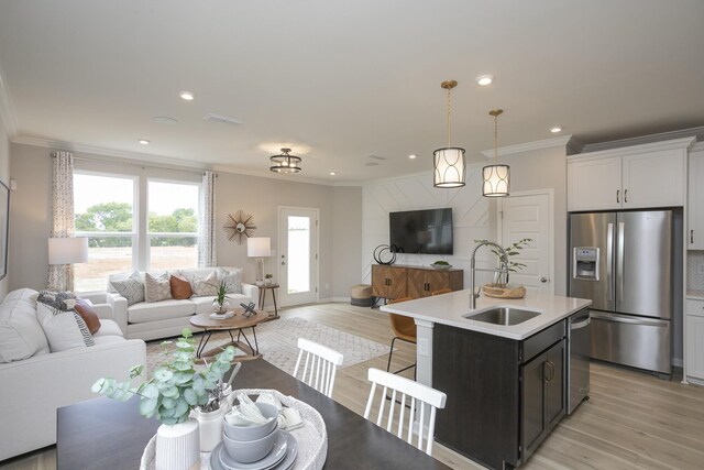 5047 Dayflower Dr, Hermitage, TN 37076 - kitchen with stainless steel appliances, a sink, open floor plan, crown molding, and light countertops