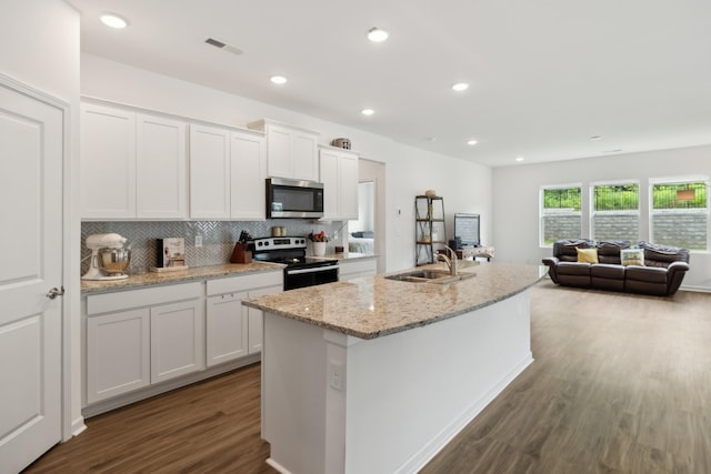 3264 Hearth Hollow Rd, Columbia, TN 38401 - kitchen featuring stainless steel microwave, electric range, a sink, dark wood finished floors, and white cabinets