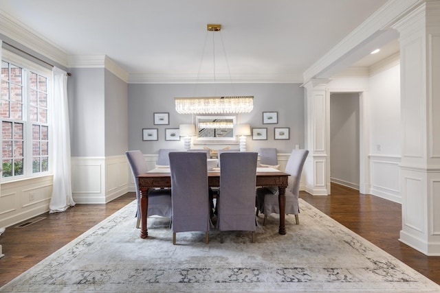 1825 Barnstaple Ln, Brentwood, TN 37027 - dining room featuring decorative columns, plenty of natural light, dark wood finished floors, ornamental molding, and a chandelier