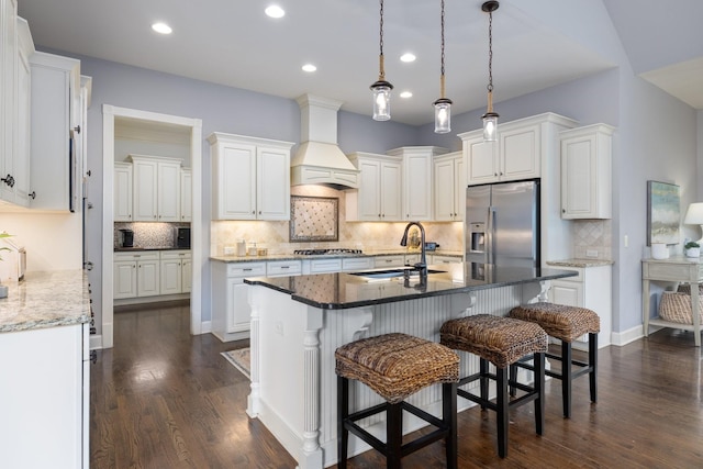 1825 Barnstaple Ln, Brentwood, TN 37027 - kitchen featuring stainless steel appliances, a sink, premium range hood, decorative backsplash, and recessed lighting