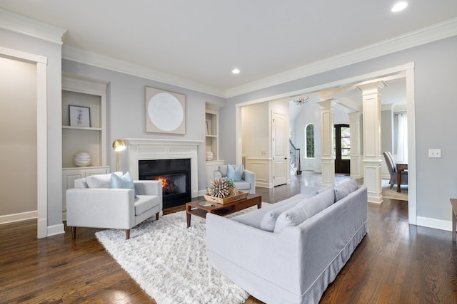 1825 Barnstaple Ln, Brentwood, TN 37027 - living room featuring ornate columns, built in shelves, ornamental molding, dark wood-type flooring, and baseboards