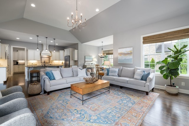 1825 Barnstaple Ln, Brentwood, TN 37027 - living room featuring a chandelier, vaulted ceiling, dark wood-style floors, healthy amount of natural light, and recessed lighting